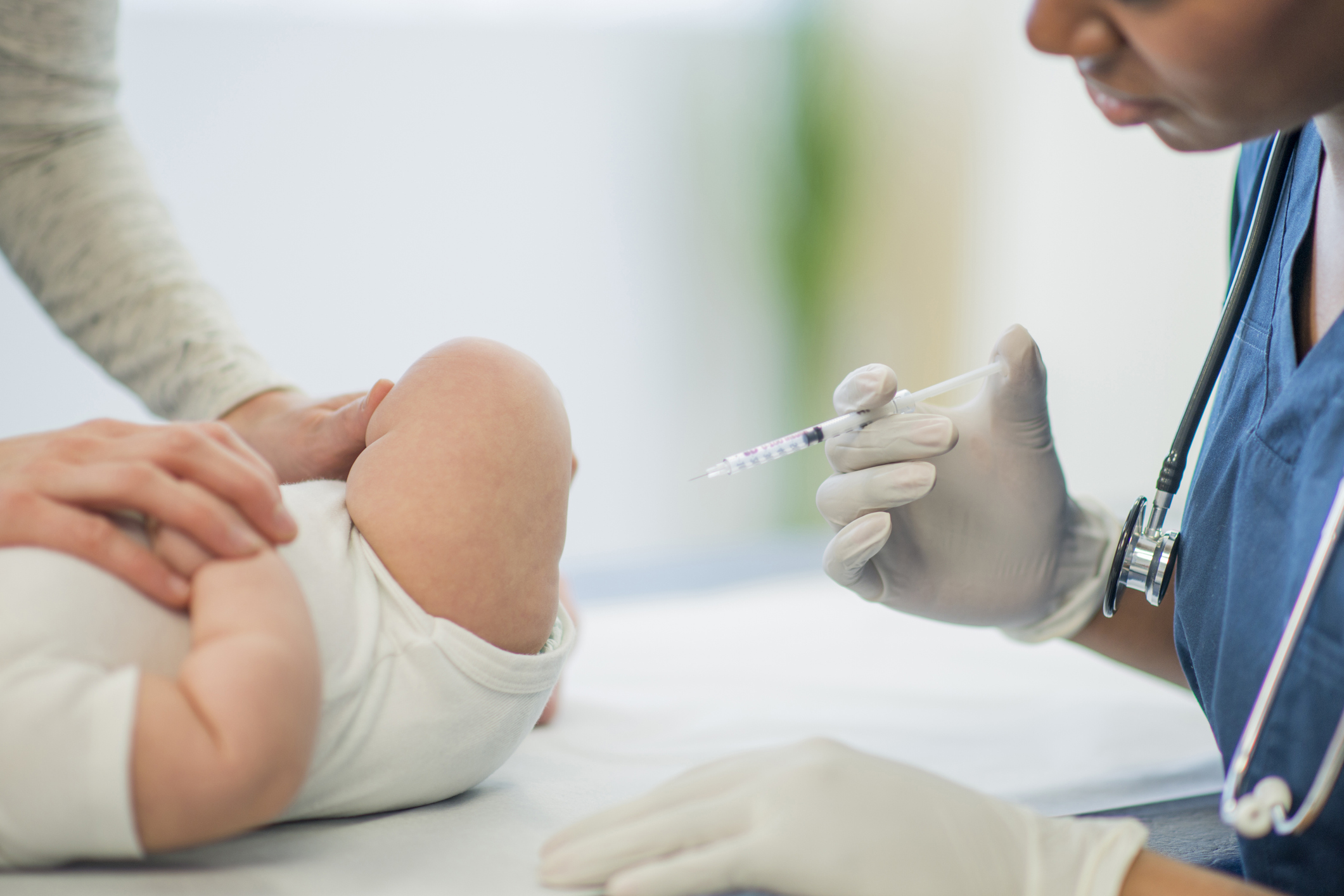 A baby receiving a vaccine injection.